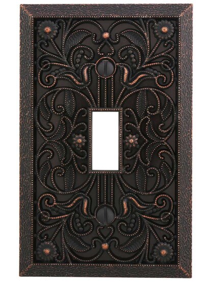 Filigree Single-Toggle Switch Plate in Aged Bronze.